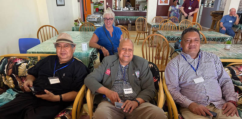 Lori sitting behind three Tongans at the South Pacific Bible Forum 2025
