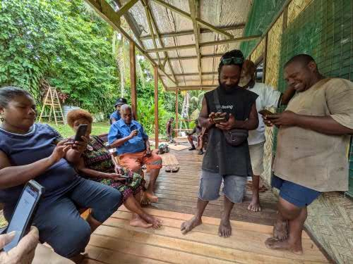 Nali-speaking people loading the Holy Bible in their language onto their smart phones